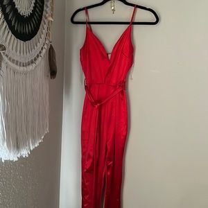 Tight red pantsuit with thin adjustable straps and a optional thin matching belt